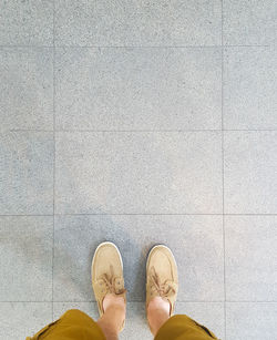 Low section of man standing on floor