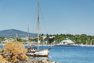 Sailboats in sea against clear blue sky