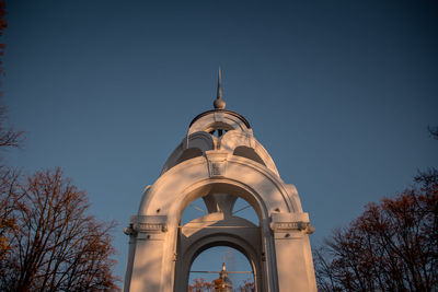 Low angle view of bell tower against blue sky