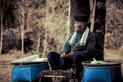 Portrait of woman sitting in forest