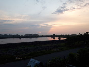 Scenic view of lake against sky during sunset