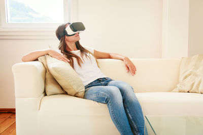 Woman sitting on sofa at home