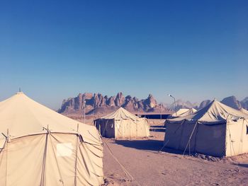 Tent on mountain against clear blue sky