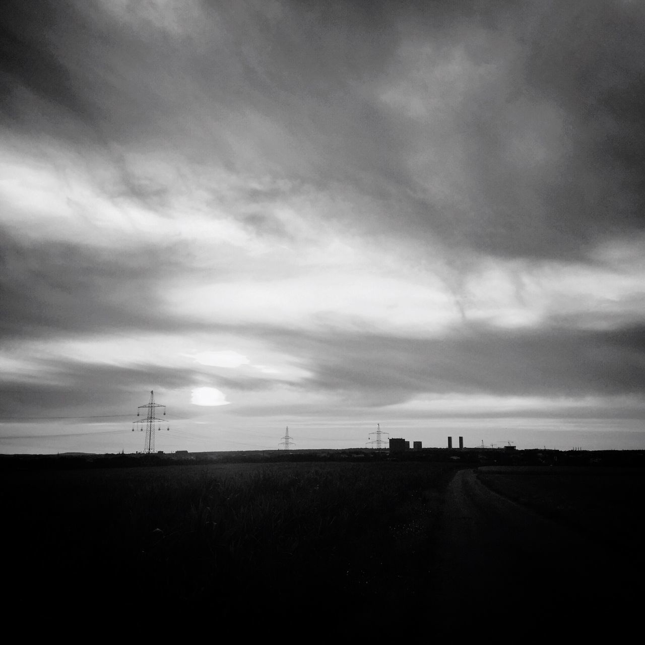 sky, landscape, cloud - sky, cloudy, field, tranquility, tranquil scene, electricity pylon, cloud, scenics, nature, rural scene, weather, overcast, horizon over land, silhouette, beauty in nature, fuel and power generation, power line, road