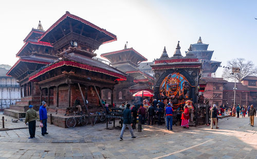 Group of people in temple outside building