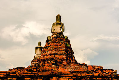 Low angle view of old building in ayutthaya province under the blue sky