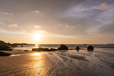 Scenic view of beach against sky during sunset