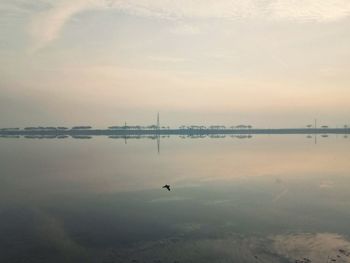 Scenic view of lake against sky during sunset