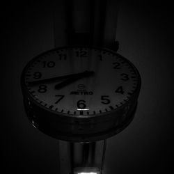 Close-up of clock over black background