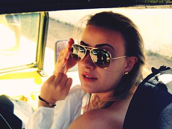 Close-up portrait of woman wearing sunglasses