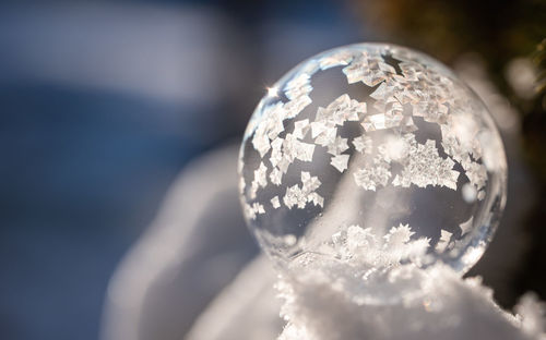 Close up image of soap bubble freezing in the snow on a winter's day.