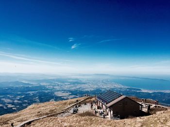 Houses on mountain against blue sky