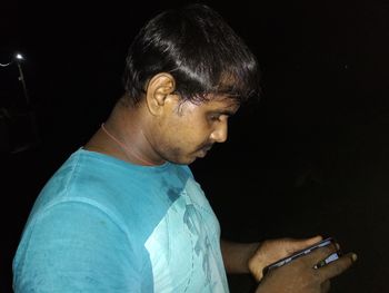 Side view of man using mobile phone