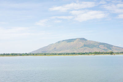 Scenic view of sea and mountains against sky