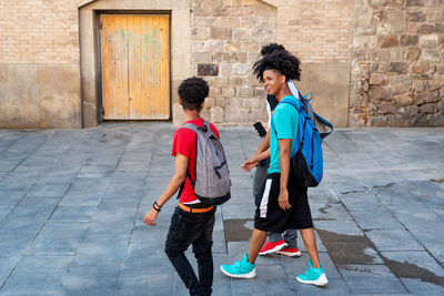 Group of afro latin male friends walking in the street