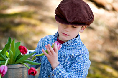 Close-up of boy with flowers