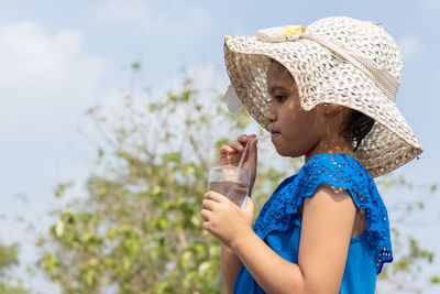 Young woman drinking water from bottle