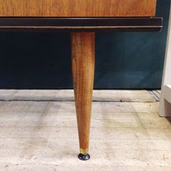 Close-up of empty wooden table against wall at home