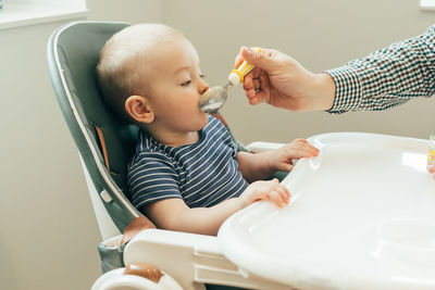 Midsection of doctor examining patient at home