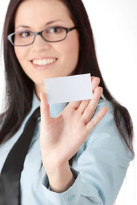 Portrait of a smiling young woman using smart phone