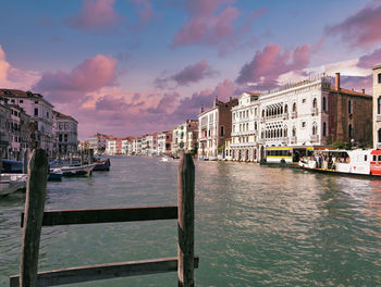 Venice, italy - a wooden fence against italian architecture on grand canal against dramatic sky