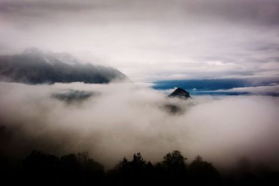 Scenic view of mountains against cloudy sky