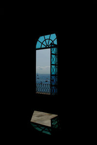 Silhouette building seen through window