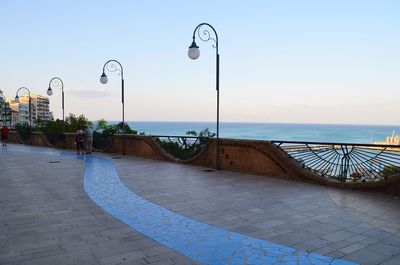 Street by swimming pool against sky