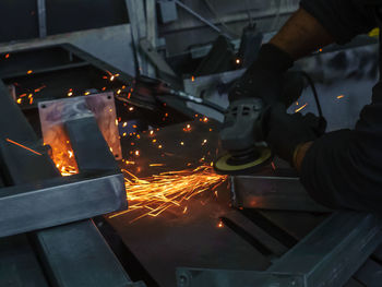 Low angle view of person working on metal