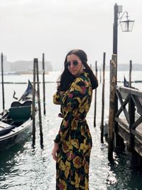 Woman standing on boat in canal