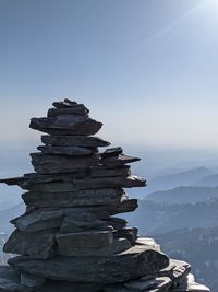 Stack of rocks on shore against sky