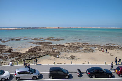 Scenic view of beach against clear blue sky