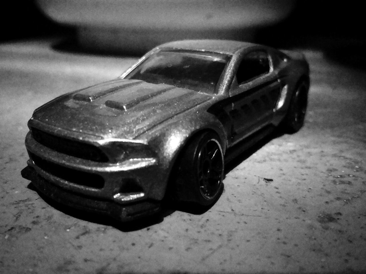 CLOSE-UP OF TOY CAR ON TABLE AT HOME