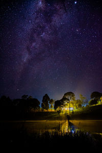 Scenic view of lake against sky at night