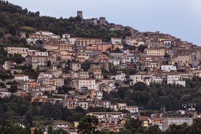 Buildings in town against sky