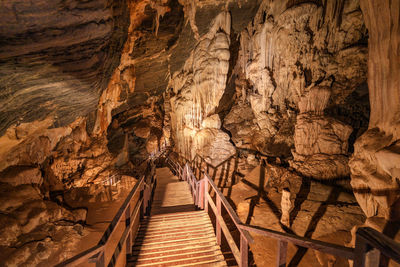 The wooden walking path through stalactite and stalagmite in phu pha petch cave at thailand