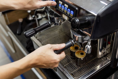 Barista make black coffee with coffee machine in cafe angle view shot