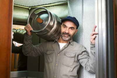 Man carrying gas cylinder at home