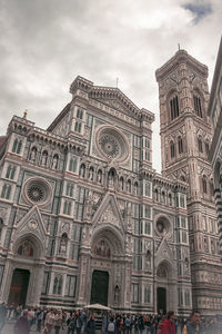 Low angle view of building against cloudy sky