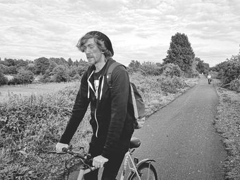 Full length of man on road amidst field against sky