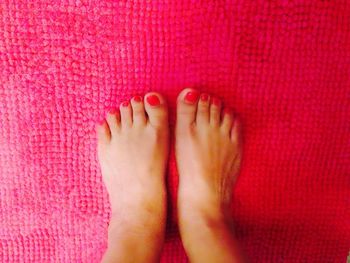 Low section of woman relaxing on tiled floor