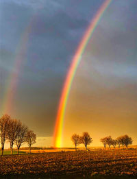 Scenic view of rainbow against sky during sunset