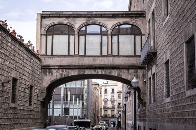 Low angle view of street amidst buildings in city