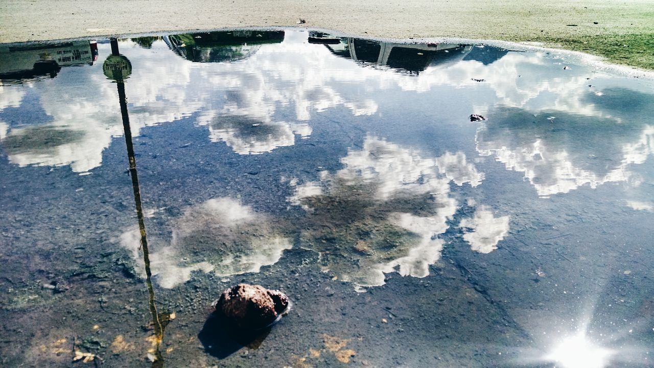 water, reflection, high angle view, puddle, transportation, lake, standing water, nautical vessel, mode of transport, nature, tranquility, wet, boat, day, moored, floating on water, outdoors, street, no people, beauty in nature