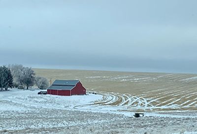 House on snow covered landscape