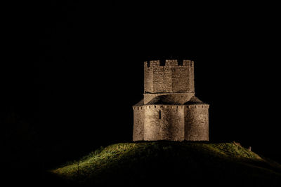 Low angle view of old tower against sky at night