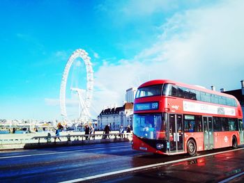 View of ferris wheel in city against sky