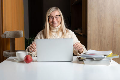 Portrait of a smiling young woman using smart phone