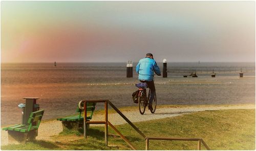 Rear view of woman standing on beach