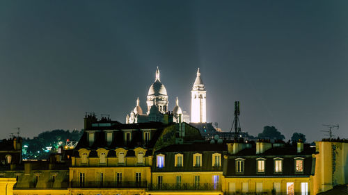 View of illuminated building against sky at night